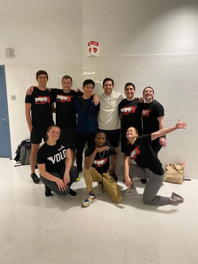 A volleyball team posing in a school hallway