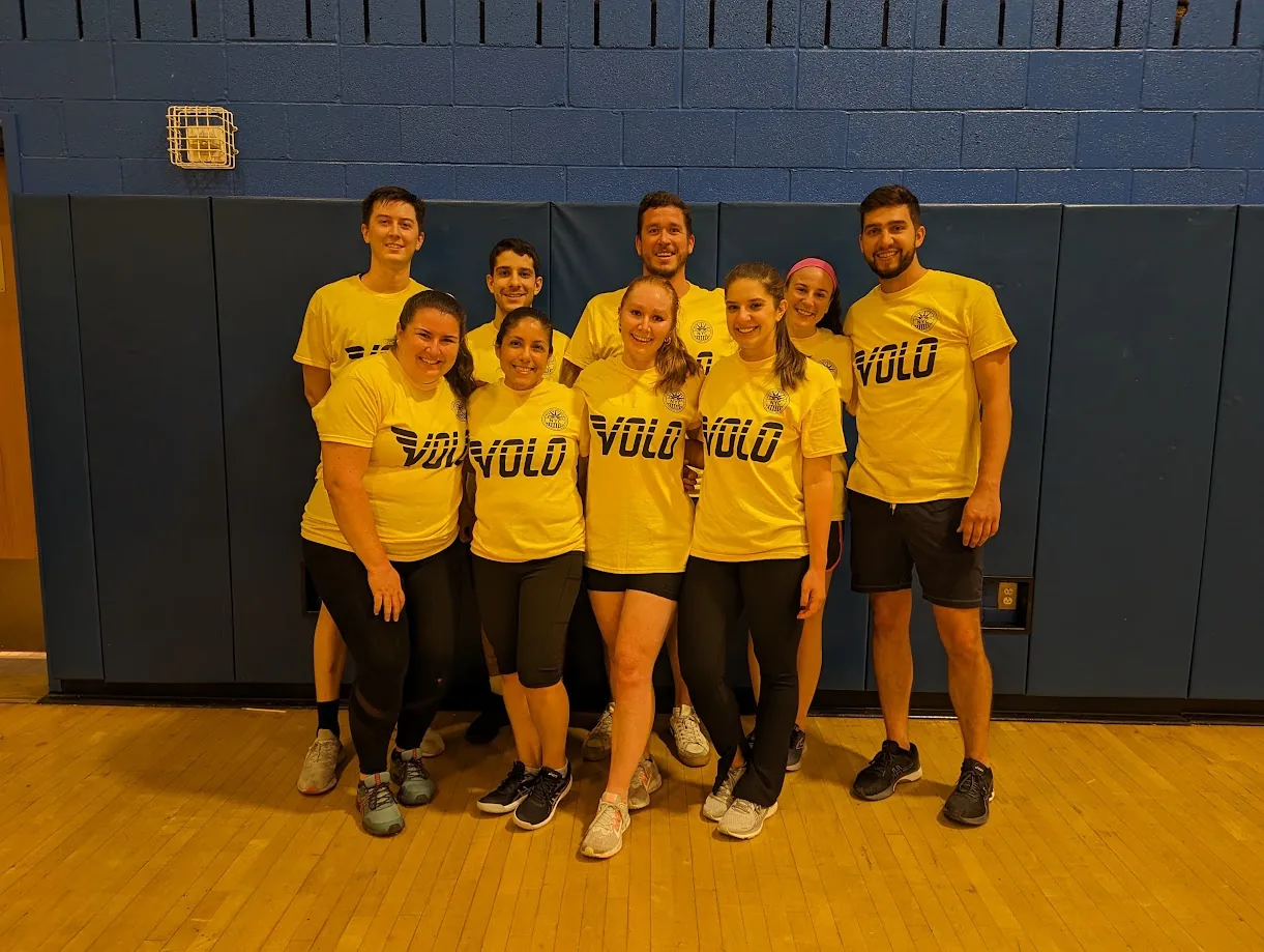 A volleyball team wearing matching yellow Volo shirts